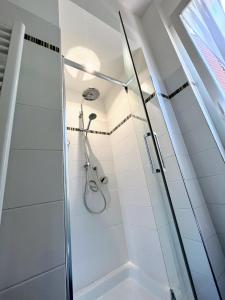 a shower with a glass door in a bathroom at Casa LL in Perugia