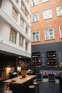 a restaurant with a table and chairs in front of a building at Home Hotel Temperance in Malmö