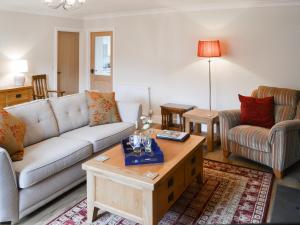 a living room with a couch and a coffee table at Number 23 in Wooler