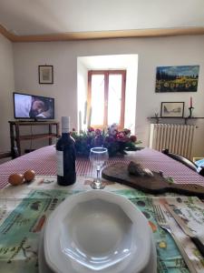 a table with a plate and a bottle of wine at I Castagnini in Montecatini Val di Cecina