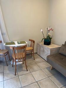 a living room with a table and chairs and a couch at Anticoleum Room in Caiazzo
