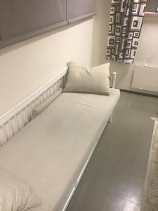 a white couch with a pillow on it in a room at Hyryntie 33 as 3 in Hyrynsalmi