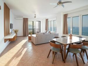 a living room with a table and a couch at Ostria View in Kardamaina