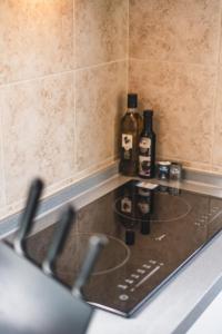 a kitchen counter with bottles of alcohol on it at Matira Tiny house 3 in Bora Bora +27 photos