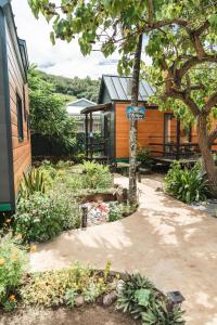a house with a sign on the side of it at Matira Tiny house 3 in Bora Bora