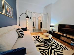 a living room with a zebra rug on the floor at Stylish City Center Apartment - with FREE PARKING space -not for big cars- 200m away in Serres