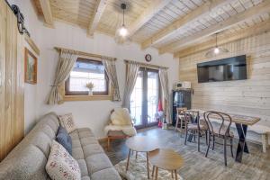 a living room with a couch and a table at Chaty Čučoriedky in Žiar