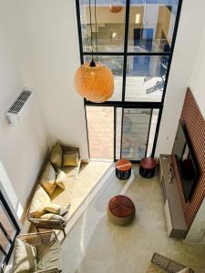 a living room with a couch and a large window at Casa Aconchegante em Japaratinga in Japaratinga