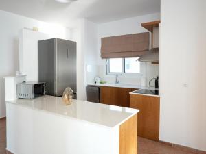 a kitchen with a white counter and a microwave at Ostria View in Kardamaina