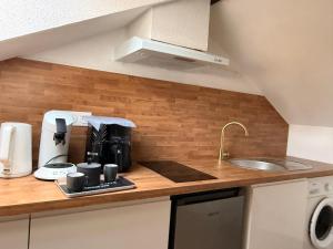 a kitchen counter with a coffee maker and a sink at Titi90 in Belfort