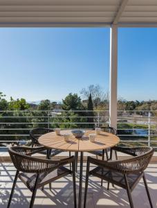 a patio with a table and chairs on a balcony at Minavra Hotel in Athens