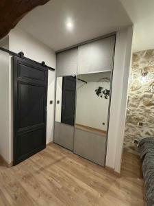 a room with a large glass door in a bedroom at Au rêve de Fadi in Bruch