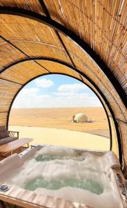 a hot tub in a tent in the desert at Sunset domes private camp in Al Raka +53 photos