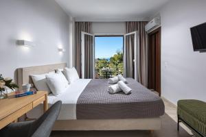 a hotel room with a bed and a window at Minavra Hotel in Athens