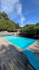 a blue swimming pool on a wooden deck at The Bay Crib in Ottawa