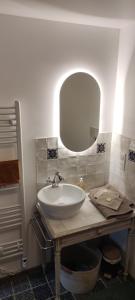 a bathroom with a sink and a mirror at L'Escalier des Rêves - Rose in Saint-Sauveur-en-Puisaye +34 photos