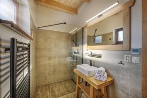 a bathroom with a sink and a mirror at Chaty Čučoriedky in Žiar +59 photos