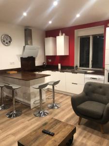 a kitchen with a island and a chair and a table at Gîte de chenieux in Saint-Victor-sur-Loire +23 photos