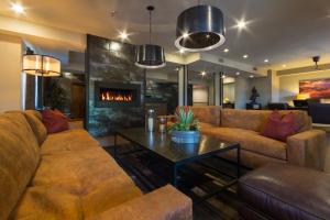 a living room with a couch and a fireplace at Arabella Hotel Sedona in Sedona