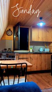 a kitchen with a table and a dining room at Nino's cottage in Sighnaghi
