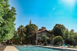 a house with a swimming pool in front of a house at Ballı Butik hotel in Kayakoy