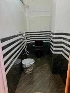 a bathroom with a black and white striped wall at 1BHK Stay in Sibsāgar