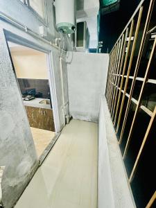 an empty room with a door and a hallway at 1BHK Stay in Sibsāgar