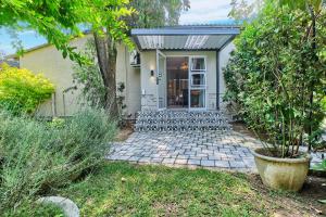 a house with a porch with chairs in the yard at Frnch on 2nd - Sandton in Johannesburg
