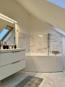 a bathroom with a sink and a shower in it at Interno Casa in Sopron +19 photos