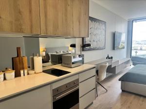 a kitchen with a stove top oven in a room at Unit 4913 - Ellipse Waterfall in Midrand