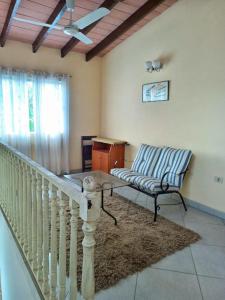 a living room with a staircase and a chair at La casa de Nimia in Asunción