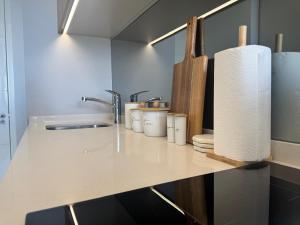 a kitchen counter with a sink and a roll of paper towels at Unit 4913 - Ellipse Waterfall in Midrand +6 photos