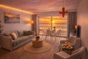 a living room with a couch and a view of the ocean at Studio zwembad met frontaal zeezicht in Ostend