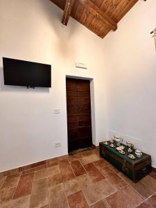 a living room with a flat screen tv on a wall at Etruscan Brothers House in Cerveteri