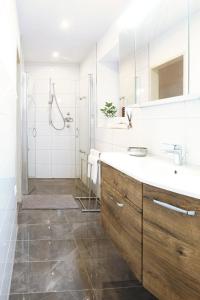 a white bathroom with a sink and a shower at Urbanihof in Jois in Jois +5 photos