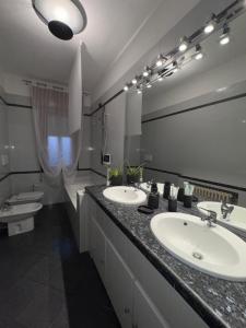 a bathroom with two sinks and a large mirror at Sweet charm in Venice in Tessera +41 photos