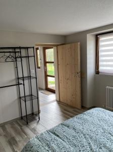 a bedroom with a bed and a room with a ladder at L'ECURIE du Château in Lebétain