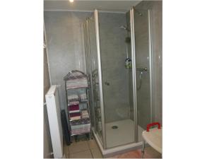 a shower with a glass door in a bathroom at Ferienwohnung Plett in Barlt +28 photos