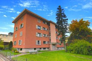 a large brick building with a bench in front of it at 3-Room Apartment Up to 5 Guests Family Business Free WiFi Netflix Sky DAZN Disney Plus 1000 International TV Channels in Wynau