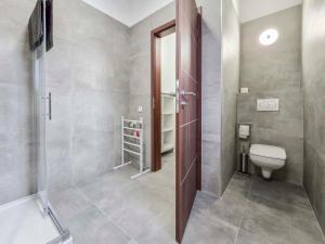 a bathroom with a toilet and a shower at PP Home in Törökbálint +11 photos