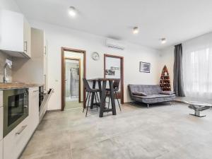 a kitchen and living room with a table and a couch at PP Home in Törökbálint