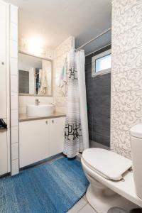 a bathroom with a toilet and a sink at Villa Giorgos in Kefalos +89 photos