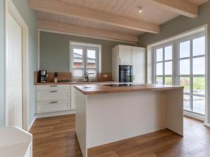 a kitchen with white cabinets and a counter top at Doppelhaushälfte in Karolinenkoog in Karolinenkoog