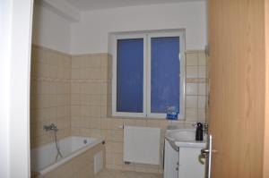 a bathroom with a tub and a sink and a bath tub at Apartment 3 Stavební in Cheb +15 photos