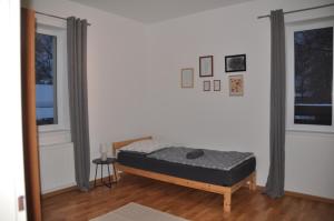 a bedroom with a bed in the corner of a room at Apartment 3 Stavební in Cheb