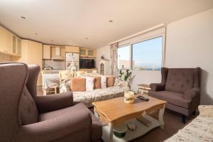 a living room with a couch and two chairs and a table at Villa Giorgos in Kefalos