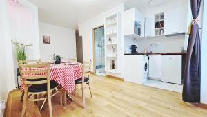 a kitchen and dining room with a table and chairs at Nice apt with parking free in Paris
