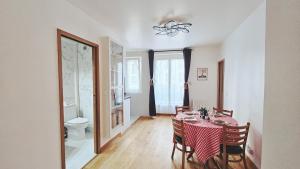 a dining room with a table and chairs and a mirror at Nice apt with parking free in Paris