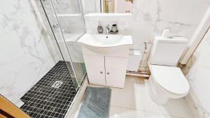 a bathroom with a toilet and a sink and a shower at Nice apt with parking free in Paris