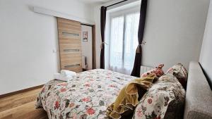 a bedroom with a bed and a window at Nice apt with parking free in Paris